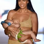 Model trends for breastfeeding baby while strutting the runway